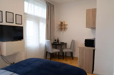 a bedroom with a bed and a table with chairs at Blue Courtyard Retreat Quiet Green View in Prague