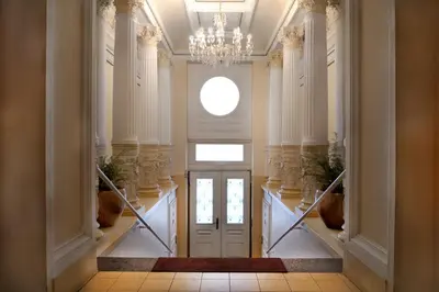 a hallway with a white door and a chandelier at Blue Courtyard Retreat Quiet Green View in Prague