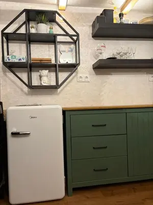 a kitchen with a white refrigerator next to a counter at Králíkova chatka in Kaliště
