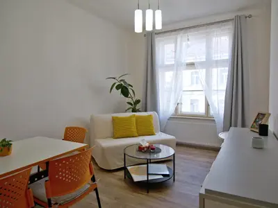 a living room with a couch and a table at Quiet and spacious flat near city centre in Prague 3 in Prague