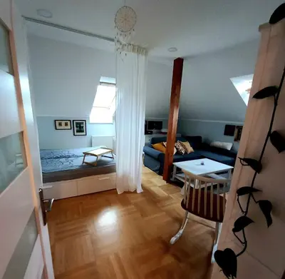 a living room with a couch and a table in a room at Apartment Dreamy Valley in Nenačovice
