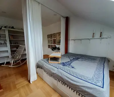 a bedroom with a bed with a table on it at Apartment Dreamy Valley in Nenačovice