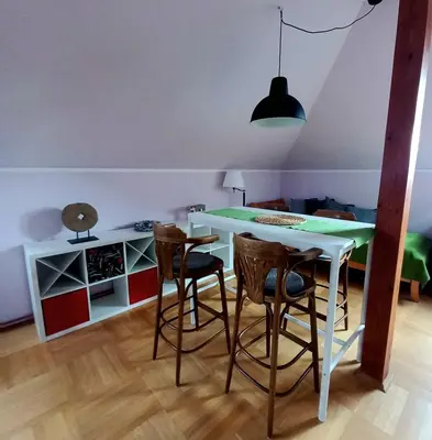 a dining room with a table and some chairs at Apartment Dreamy Valley in Nenačovice
