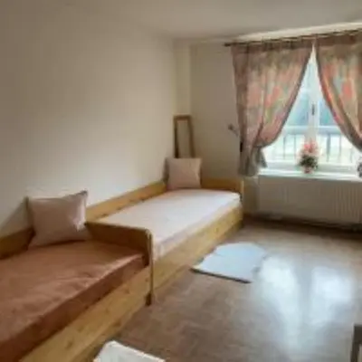 a small room with a bed and a window at Apartment in a family home in Chocerady