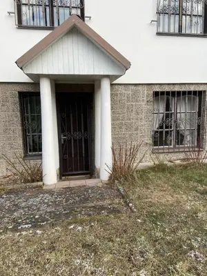 a front door of a building with windows at Apartment in a family home in Chocerady