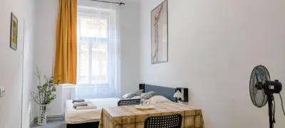 a living room with a table and a couch at Nový pokoj u Pražského výstaviště A3 in Prague