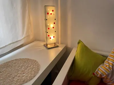 a lamp sitting on a table next to a couch at Apartment Flora Lobkovic in Prague