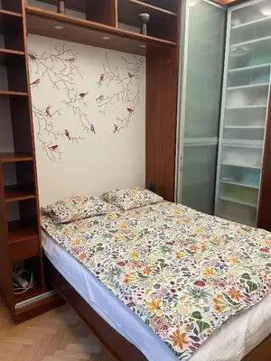 a bed with a floral comforter in a bedroom at Apartment Flora Lobkovic in Prague