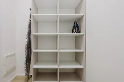 a walk in closet with white shelves at Blueground Holešovice museums foodie area PRG-11 in Prague