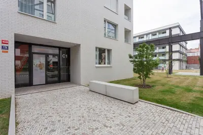 a white building with a bench in front of it at Blueground Holešovice museums foodie area PRG-11 in Prague
