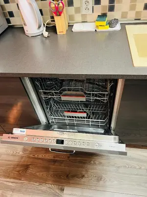 an oven is open on a kitchen counter at Chodov apartmán in Prague