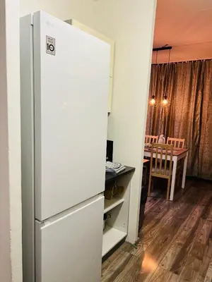 a refrigerator in a room with a table at Chodov apartmán in Prague