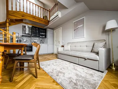 a living room with a couch and a table at Under the Bells of Týn Church in Prague