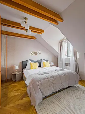 a bedroom with a large bed in a attic at Under the Bells of Týn Church in Prague