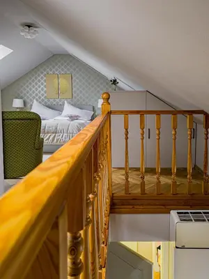 a staircase leading to a bedroom with a bed at Under the Bells of Týn Church in Prague