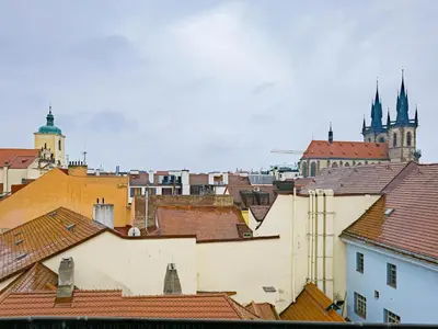 a view of roofs of buildings and a cathedral at Under the Bells of Týn Church in Prague