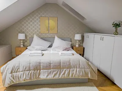 a bedroom with a bed and two lamps at Under the Bells of Týn Church in Prague