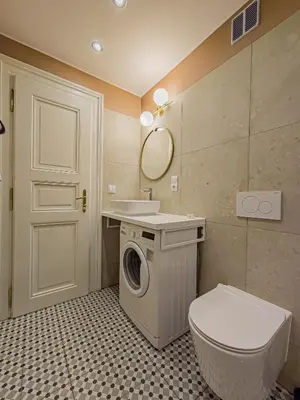 a bathroom with a washing machine and a toilet at Under the Bells of Týn Church in Prague