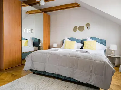 a bedroom with a large bed and a mirror at Under the Bells of Týn Church in Prague
