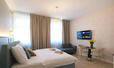 a bedroom with a bed and a living room at Luxemi Apartments I Wenceslas Square in Prague