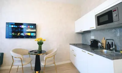a small kitchen with a table and a microwave at Luxemi Apartments I Wenceslas Square in Prague