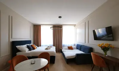 a hotel room with two beds and a couch at Luxemi Apartments I Wenceslas Square in Prague