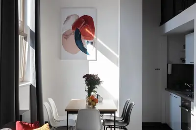 a dining room with a table and chairs at Family duplex apartment near center in Prague
