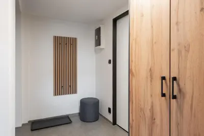 a room with a door and a stool next to a wall at Family duplex apartment near center in Prague