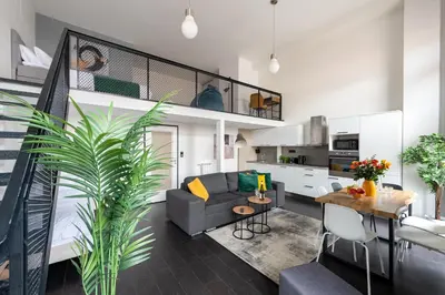 a living room with a couch and a table at Family duplex apartment near center in Prague
