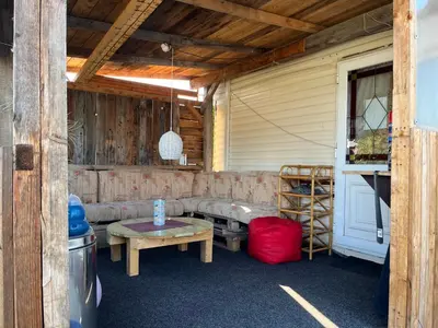 a porch with a couch and a table and a ladder at Mobilheim Natálka in Račice