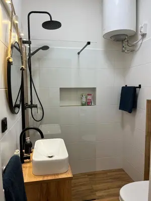a bathroom with a sink and a shower at Bright and cozy studio 15 minutes to city center in Prague