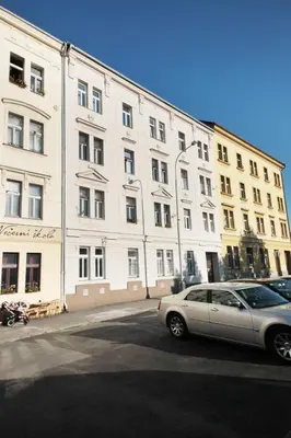 a car parked in front of a large white building at Bright and cozy studio 15 minutes to city center in Prague