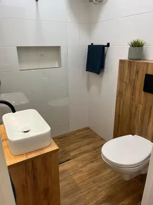 a bathroom with a white toilet and a sink at Bright and cozy studio 15 minutes to city center in Prague