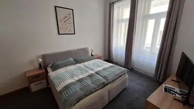 a bedroom with a bed and a television in it at City center apartment Thomas No3 in Prague