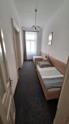 two beds in a room with a window at City center apartment Thomas No3 in Prague