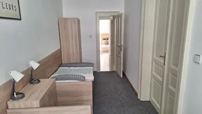 a small room with a bed and a desk with lamps at City center apartment Thomas No3 in Prague