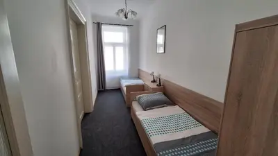 a room with two beds and a window at City center apartment Thomas No3 in Prague