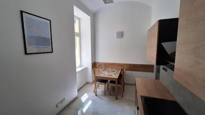 a small dining room with a table and a window at City center apartment Thomas No3 in Prague