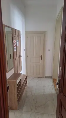a room with a wooden bench and a door at City center apartment Thomas No3 in Prague
