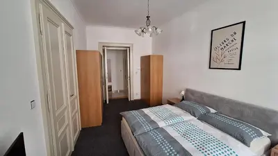 a bedroom with a bed with blue pillows on it at City center apartment Thomas No3 in Prague