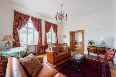 a living room with a couch and a table at Stay Beneath Prague Castle Where Mozart Performed in Prague