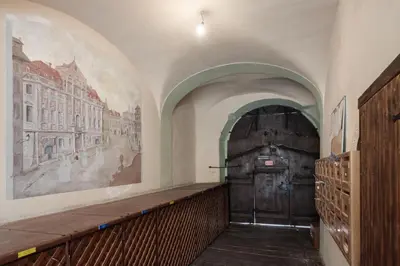 a hallway with a large wooden door in a building at Stay Beneath Prague Castle Where Mozart Performed in Prague