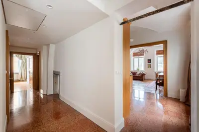a hallway of a home with white walls and wood floors at Stay Beneath Prague Castle Where Mozart Performed in Prague