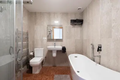 a bathroom with a tub and a toilet and a sink at Stay Beneath Prague Castle Where Mozart Performed in Prague