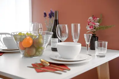 a table with a bowl of fruit and wine glasses at Cozy nest - Perfect for Two in Prague