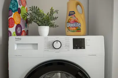 a washing machine with a bottle of laundry detergent at Cozy nest - Perfect for Two in Prague