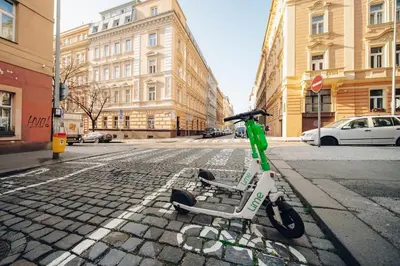 a green and white scooter parked on a street at Cozy nest - Perfect for Two in Prague