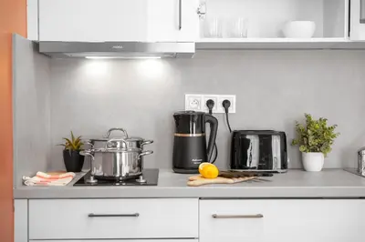 a kitchen counter with a stove with pots and pans at Cozy nest - Perfect for Two in Prague