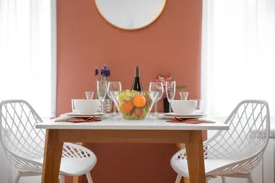 a dining room table with fruit and wine bottles at Cozy nest - Perfect for Two in Prague