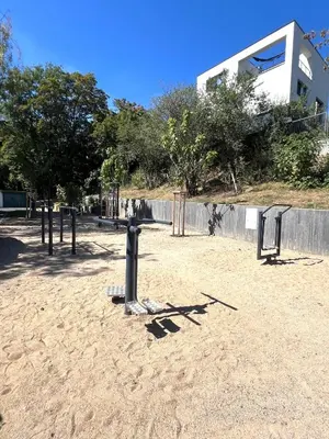 a park with a bunch of playground equipment in the sand at Apartment Sport & Sauna Prague in Prague